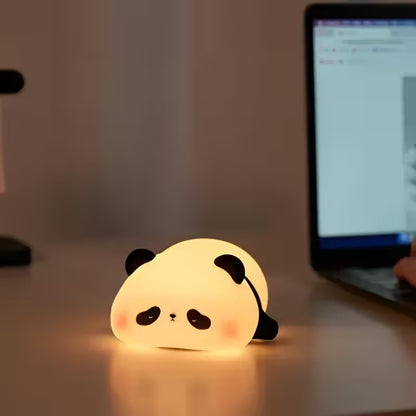 Panda-shaped night light on a desk with a laptop