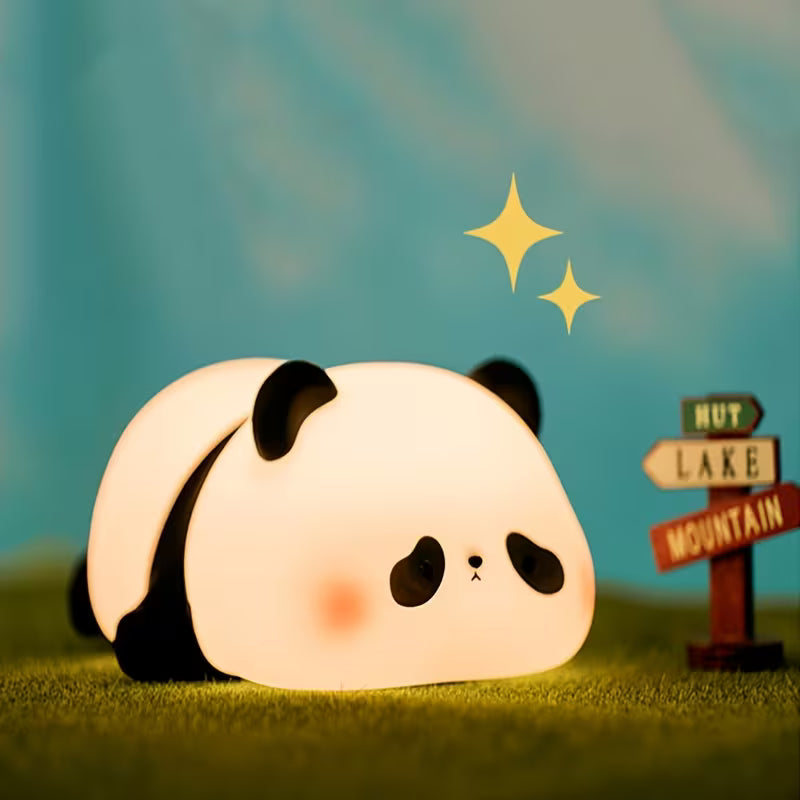 Panda-shaped night light on grass